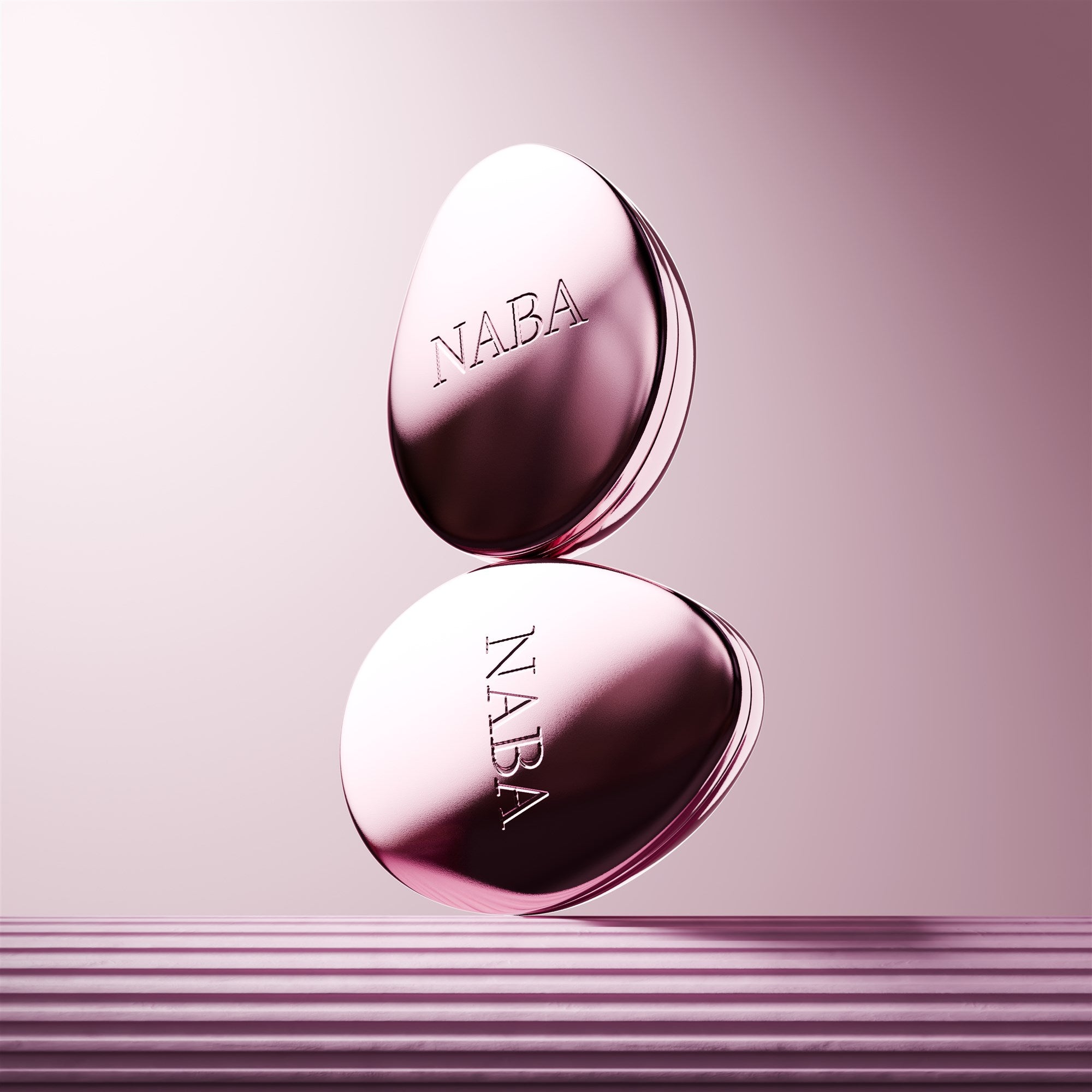 Two Rose Gold NABA cases in a floating composition against a rose-coloured background